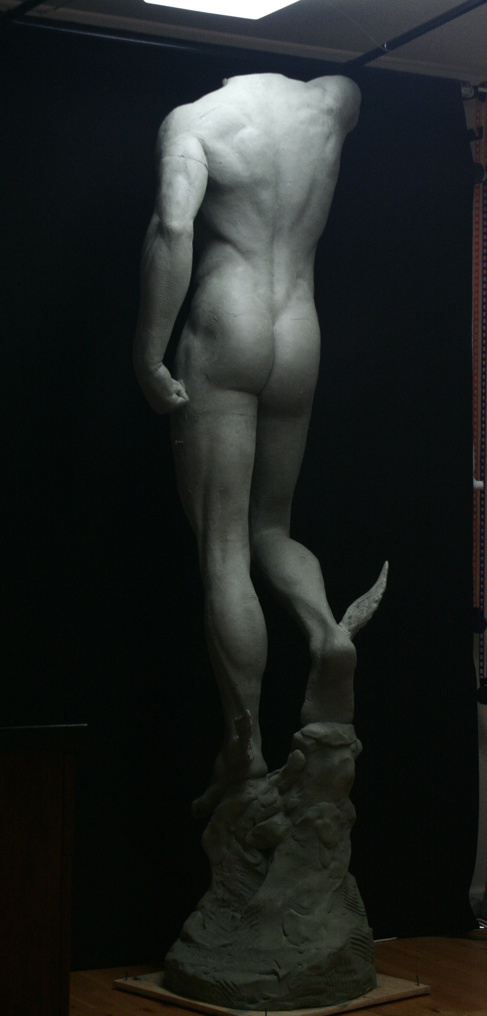 Studio in progress image of Mercury sculpture from behind with head removed