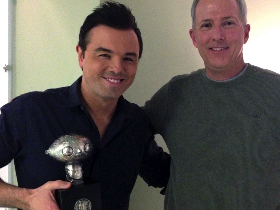 Seth MacFarlane receiving Stewie Griffin sculpture from artist Richard Becker at Fuzzy Door Productions in Los Angeles